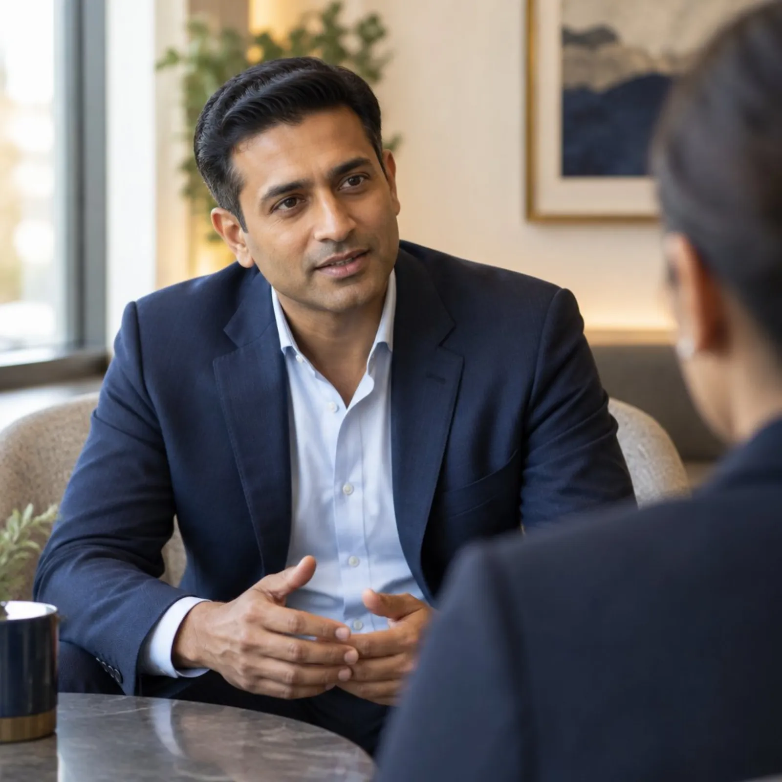 A professional speaking with quiet confidence in a one-to-one conversation